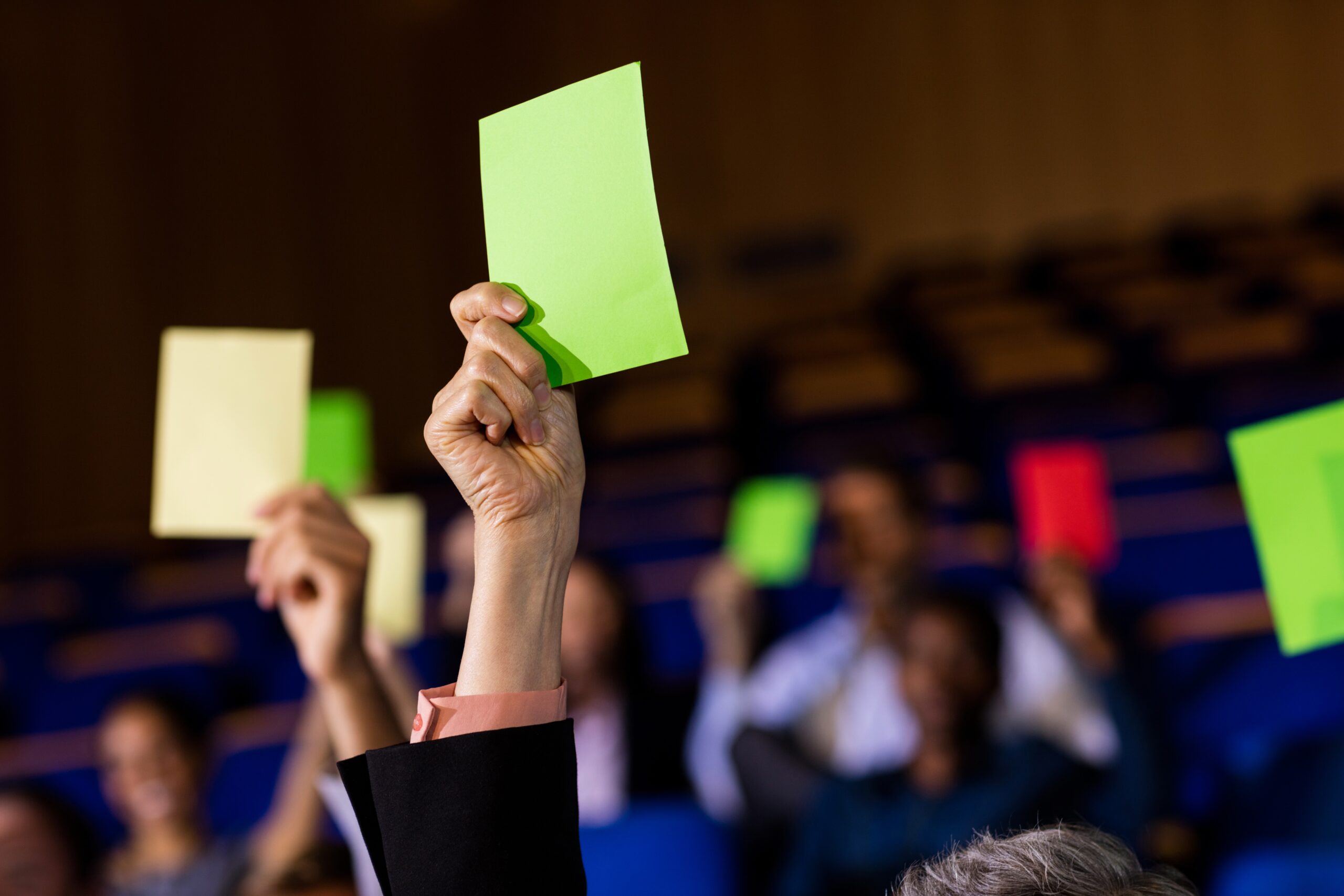 business executives show their approval by raising hands (1)